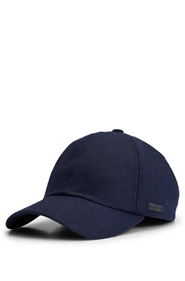 Wool cap with faux-leather logo label