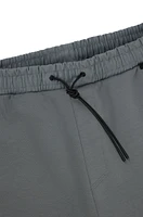 Tracksuit bottoms with decorative reflective logo