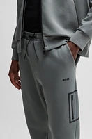 Tracksuit bottoms with decorative reflective logo