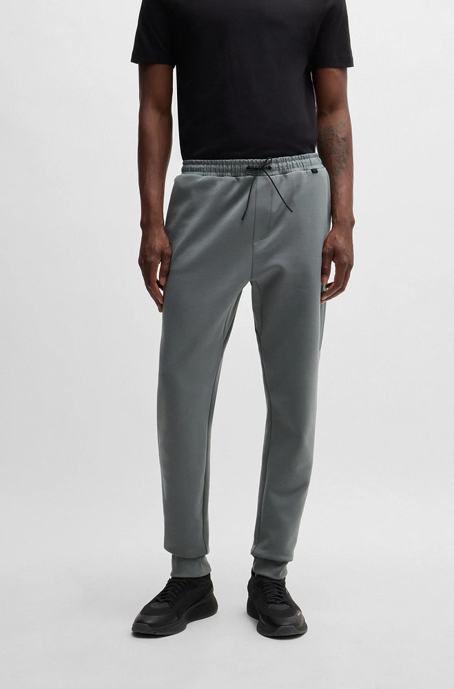 Tracksuit bottoms with decorative reflective logo