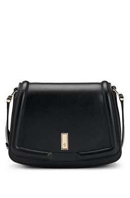 Leather saddle bag with signature hardware and monogram