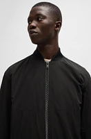 Water-repellent jacket with zipped sleeve pocket