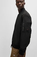 Water-repellent jacket with zipped sleeve pocket