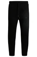 Tracksuit bottoms with mirror-effect logo