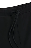 Tracksuit bottoms with mirror-effect logo