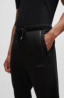 Tracksuit bottoms with mirror-effect logo