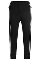 Tracksuit bottoms with tape inserts