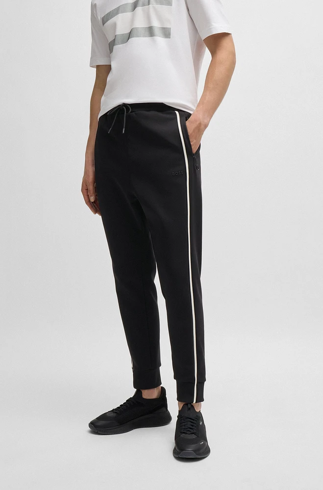 Tracksuit bottoms with tape inserts