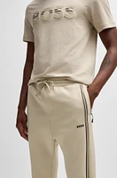 Tracksuit bottoms with tape inserts