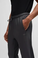 Active-stretch tracksuit bottoms with decorative reflective details