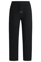 Tracksuit bottoms with adjustable hems