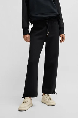 Tracksuit bottoms with adjustable hems