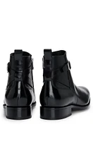 Leather jodhpur boots with zip closure and buckled strap