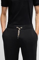 Tracksuit bottoms with signature-stripe cords