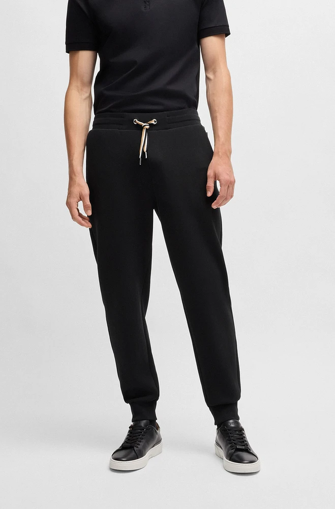 Tracksuit bottoms with signature-stripe cords