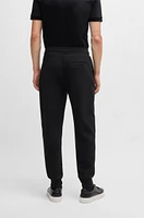 Tracksuit bottoms with signature-stripe cords