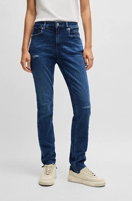 Blue jeans distressed stretch denim with frayed hems