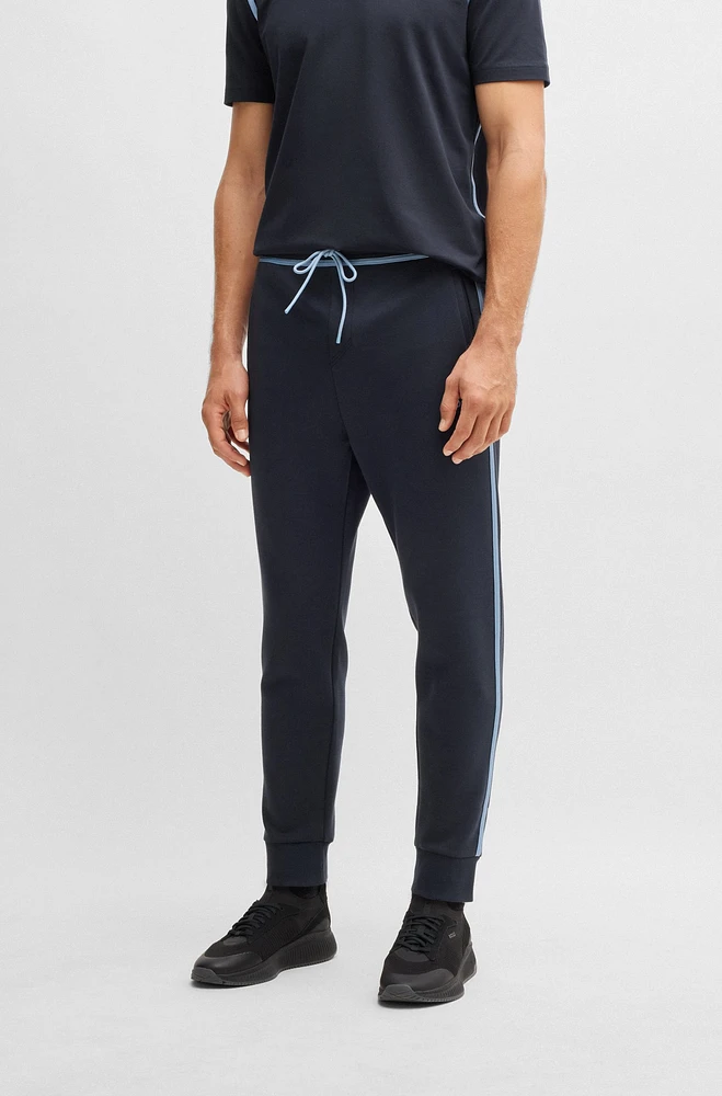 Tracksuit bottoms with tape and logo