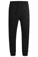 Stretch tracksuit bottoms with logo patch