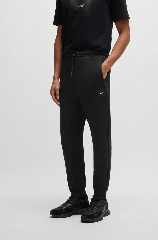 Stretch tracksuit bottoms with logo patch