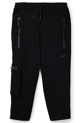 Kids' tracksuit bottoms stretch piqué with patch pocket