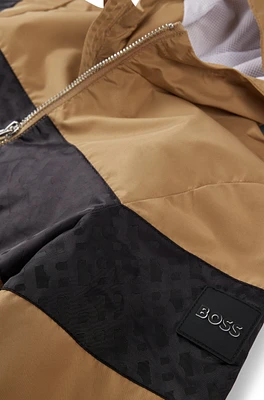 Kids' water-repellent hooded windbreaker with monogram detailing