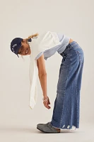 The Adi Regenerative Cotton Mid-Rise Frayed Relaxed Flare Jeans by Pilcro