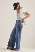 The Adi Regenerative Cotton Mid-Rise Frayed Relaxed Flare Jeans by Pilcro