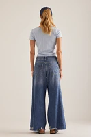 The Adi Regenerative Cotton Mid-Rise Frayed Relaxed Flare Jeans by Pilcro