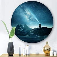 Designart - A Man Shining A Light Into The Night Sky