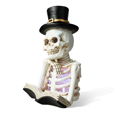 Glitzhome® 10" Lighted Halloween Resin Skull Reading Book Table Décor