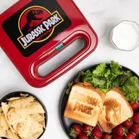 Uncanny Brands Jurassic Park Grilled Cheese Maker- Panini Press and Compact Indoor Grill- Opens 180 Degrees