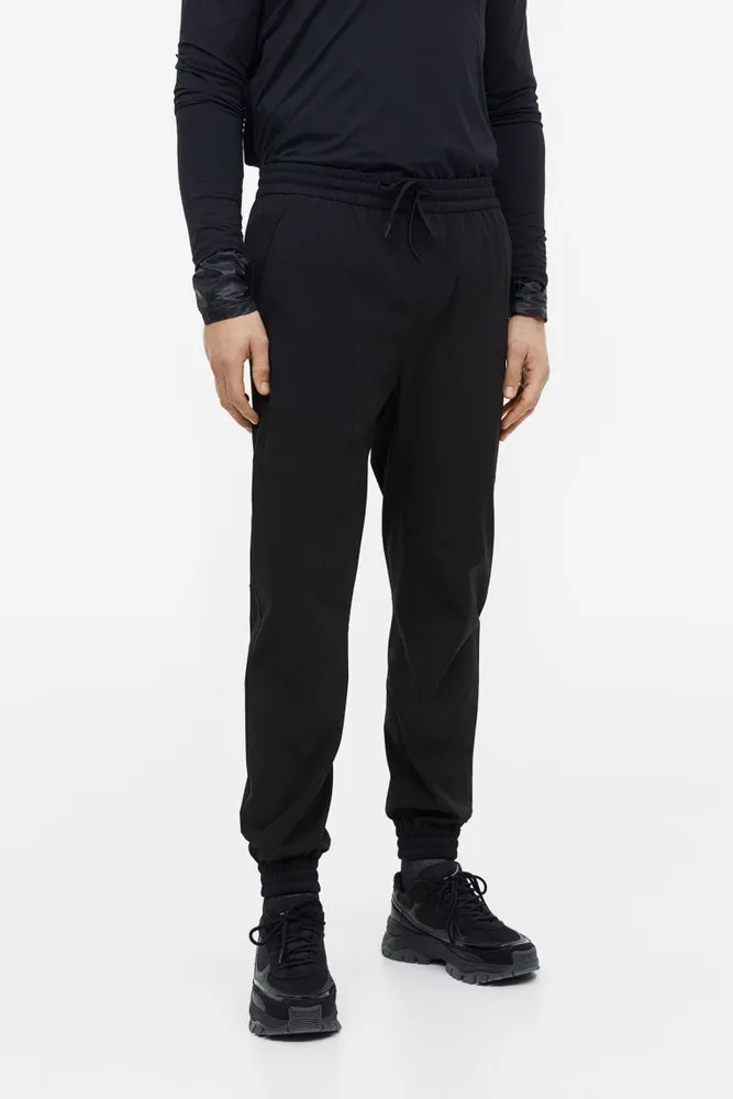 DryMove™ Tapered tech joggers with zipped pockets - Black - Men