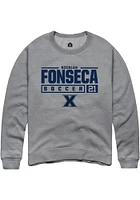 Nicolas Fonseca  Rally Xavier Musketeers Mens Graphite NIL Stacked Box Long Sleeve Crew Sweatshi..