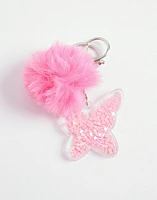 Llavero con pompon y aplique de pvc en forma de mariposa con glitter movible