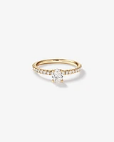 0.73 Carat TW Oval Cut Diamond and Round Brilliant Side Accent Engagement Ring in 14kt Yellow Gold