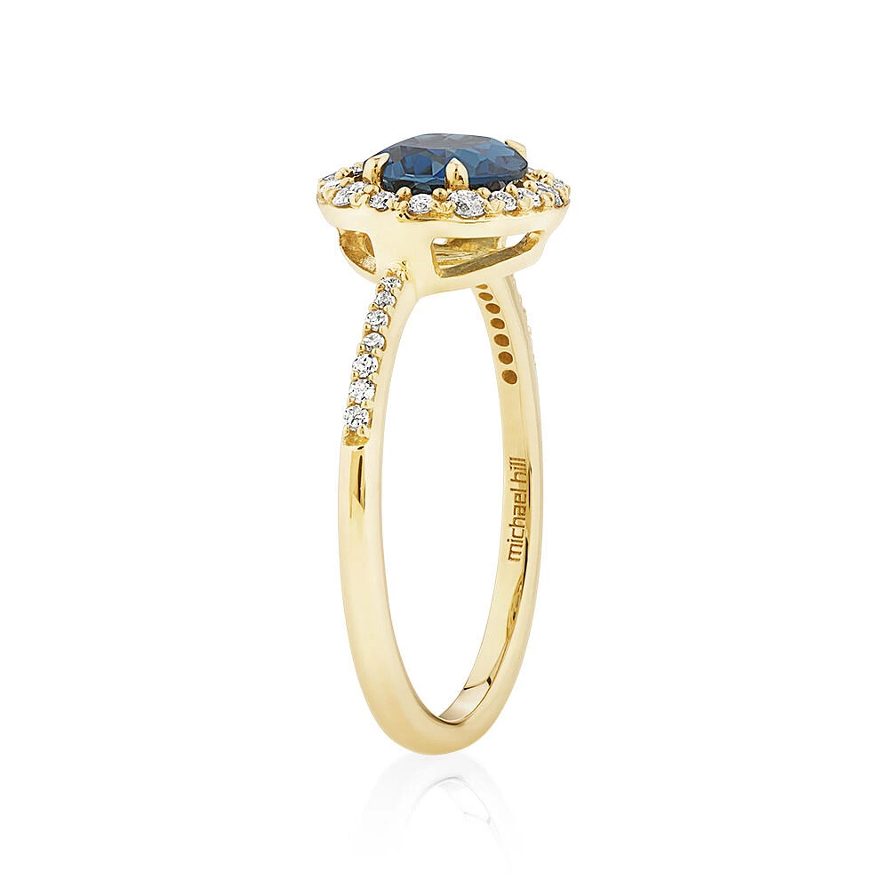 Halo Ring with London Blue Topaz & 0.25 Carat TW of Diamonds in 10kt Yellow Gold