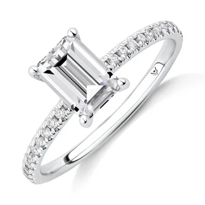 Engagement Ring with 1.14 Carat TW of Diamonds. A 1 Emerald Cut Centre Laboratory-Grown Diamond and shouldered by 0.14 Natural Diamonds 14kt White Gold