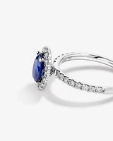 Oval Cut Blue Sapphire Gemstone and 0.60 Carat TW Diamond Halo Ring in 14kt White Gold