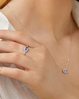 Halo Ring with Tanzanite & 0.15 Carat TW Of Diamonds in 10kt White Gold