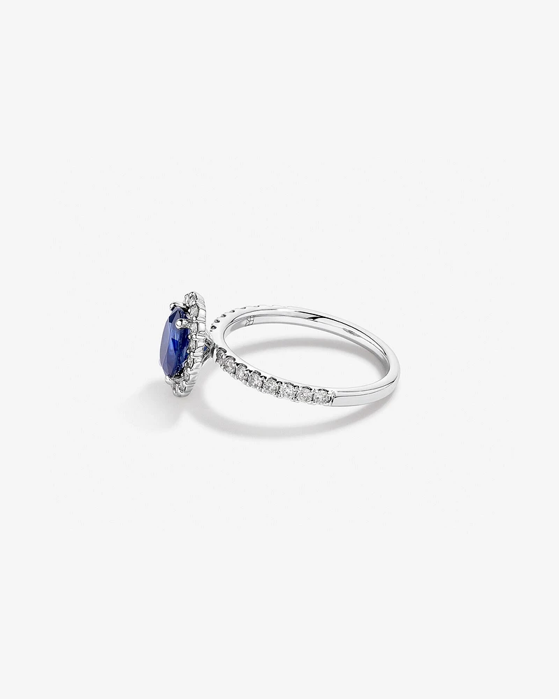 Oval Cut Blue Sapphire Gemstone and 0.60 Carat TW Diamond Halo Ring in 14kt White Gold