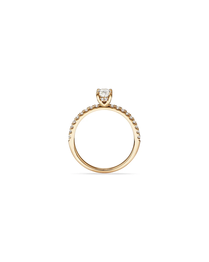 0.73 Carat TW Oval Cut Diamond and Round Brilliant Side Accent Engagement Ring in 14kt Yellow Gold