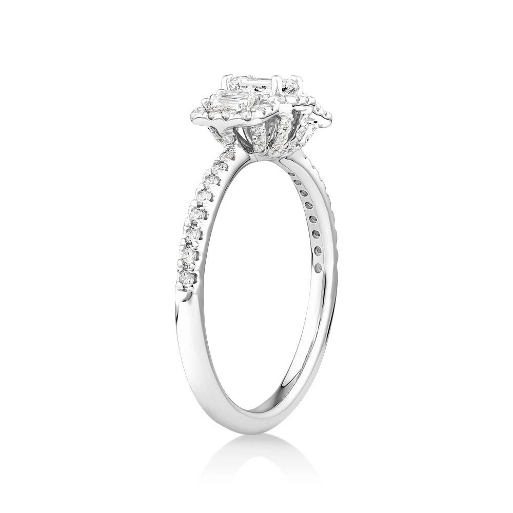 0.80 Carat TW Three Stone Emerald Cut Halo Engagement Ring in 14kt White Gold