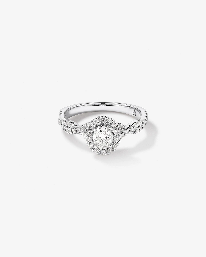 0.75 Carat TW Oval Cut Diamond Twist Side Accent Halo Engagement Ring in 14kt White Gold