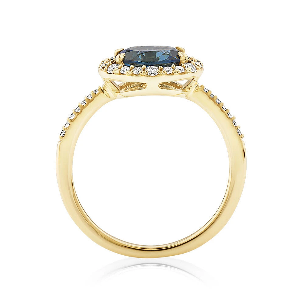 Halo Ring with London Blue Topaz & 0.25 Carat TW of Diamonds in 10kt Yellow Gold