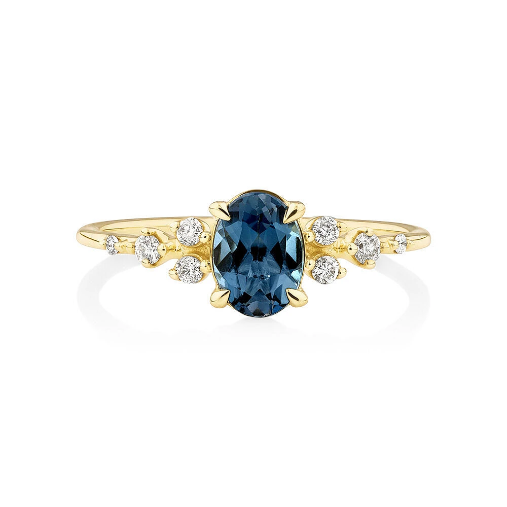 Ring with Blue Topaz and 0.12 Carat TW of Diamonds 10kt Yellow Gold