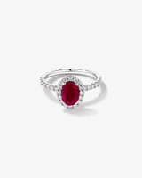 Oval Cut Red Ruby Gemstone and 0.60 Carat TW Diamond Halo Ring in 14kt White Gold