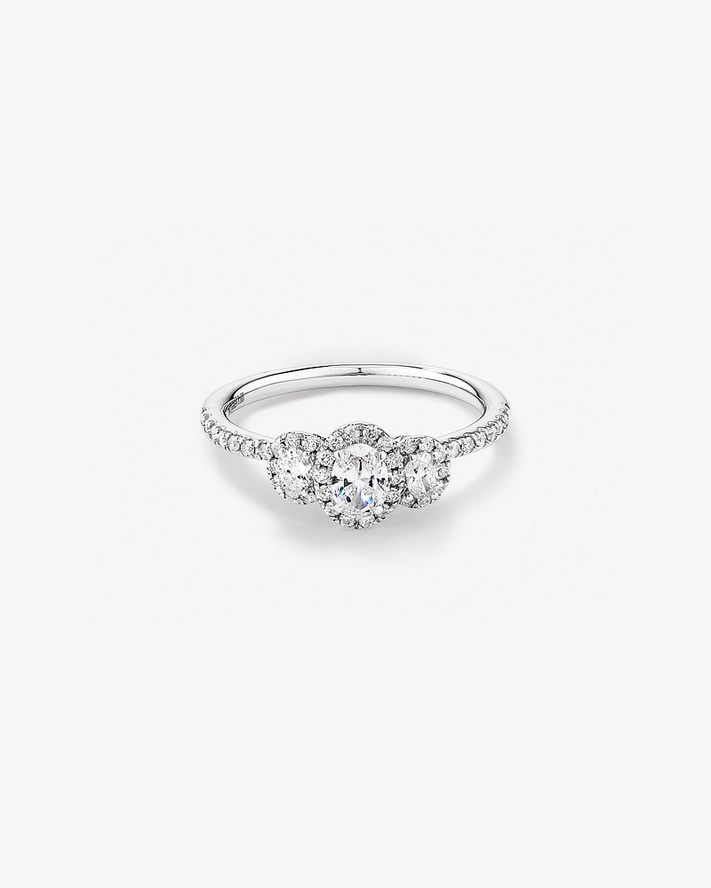 0.77 Carat TW Three Stone Oval Cut Halo Engagement Ring in 14kt White Gold