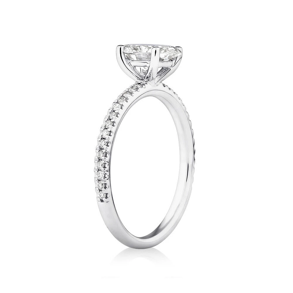 Engagement Ring with 1.14 Carat TW of Diamonds. A 1 Carat Oval Centre Laboratory-Grown Diamond and shouldered by 0.14 Carat TW of Natural Diamonds in 14kt White Gold