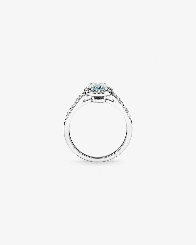 Oval Cut Blue Aquamarine Gemstone and 0.29 Carat TW Diamond Halo Ring in 10kt White Gold